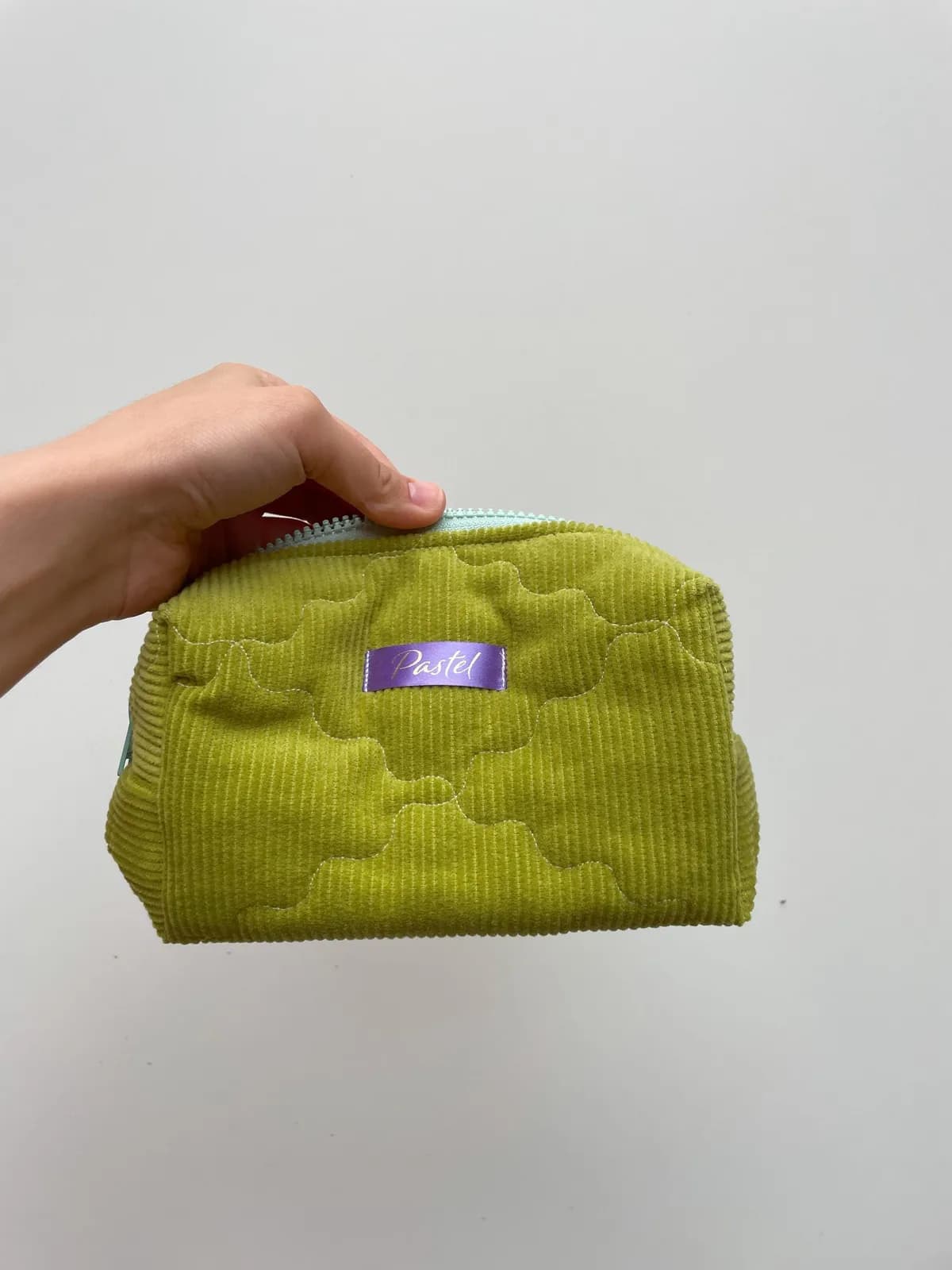 Green quilted corduroy toiletry pouch - front view